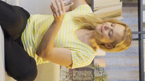 Vertical video of The sick woman drinks a lot of water.