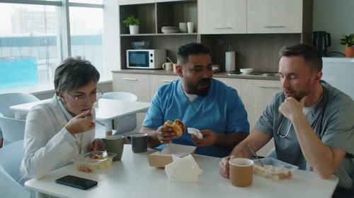 Colleagues Having Lunch and Talking in Hospital Break Room