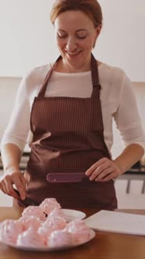 Woman prepares meringues in a kitchen