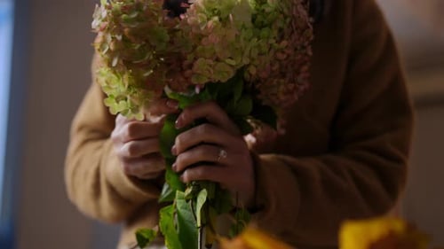 Woman Arranging Hydrangea Flower Bouquet at Home
