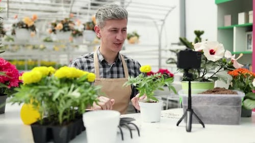 Man Presents Gardening Tutorial on Smartphone
