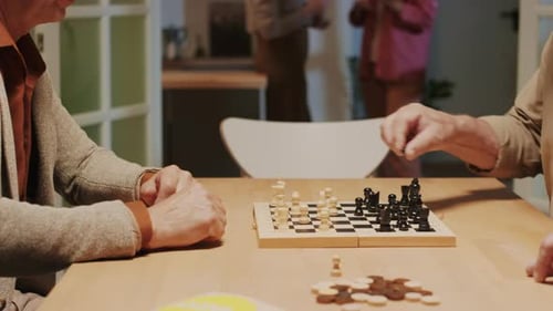 Senior Adults Play Chess Together Indoors