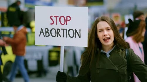 Woman Protesting Abortion on City Street