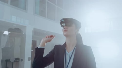 Woman Using Augmented Reality Headset in Modern Workplace