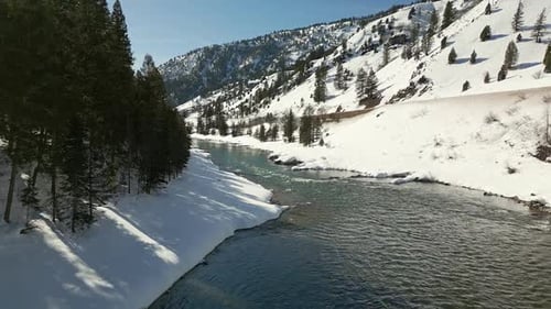 Flying through winter landscape down towards the Snake River
