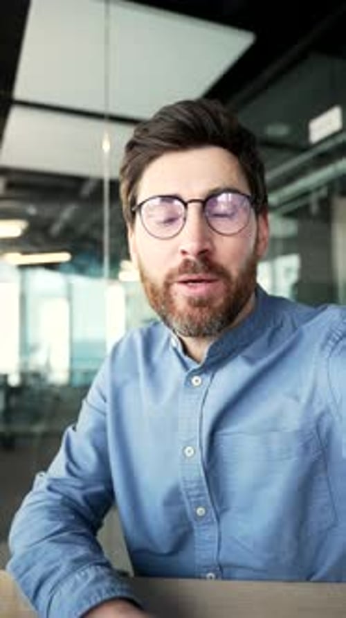 Man Explains and Waves During a Video Call