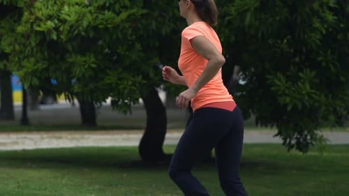 Young Woman Jogging in City Park, Super 240