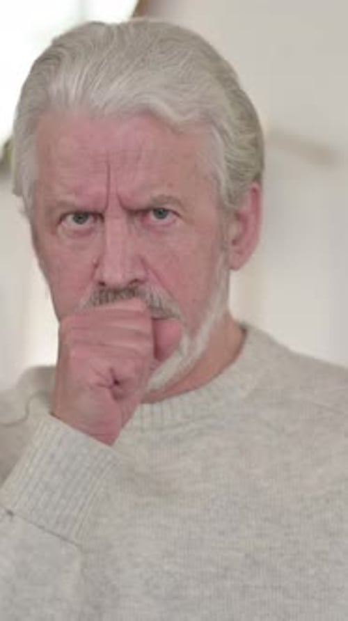 Senior Man Coughing with Uncomfortable Facial Expression Close-up