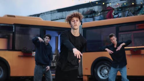 Teenagers Dancing in Front of Urban Bus Art