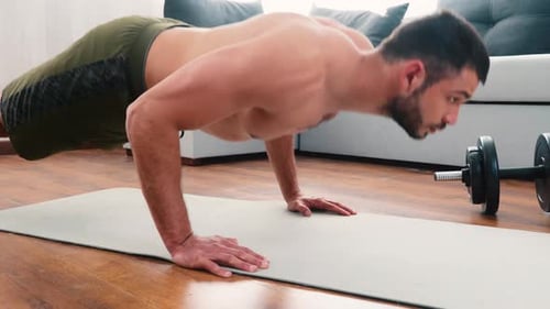 Muscular Man Doing Pushups on Yoga Mat at Home