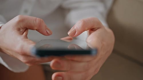 Woman Using Smartphone in Close Up Indoors