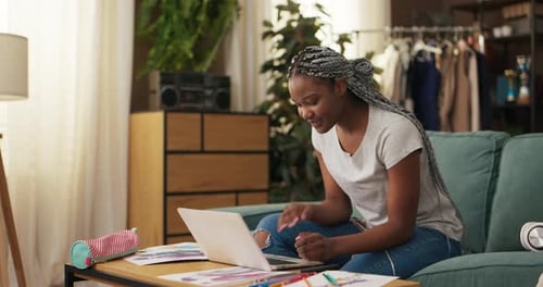 Young Woman Using Laptop Computer in Home