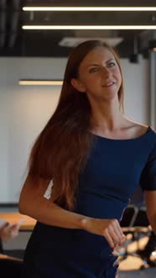 Vertical of Sexy Businesswoman Happy Dancing Inside of Modern Office
