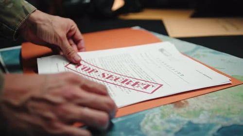 Man Reviews Top Secret Documents in Office