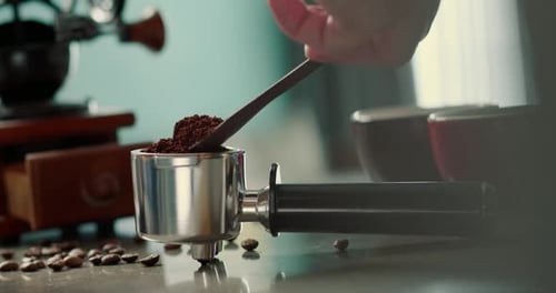 Man Pouring Ground Coffee View Hand From a Wooden Spoon Pours Ground Coffee Into a Coffee Brewing