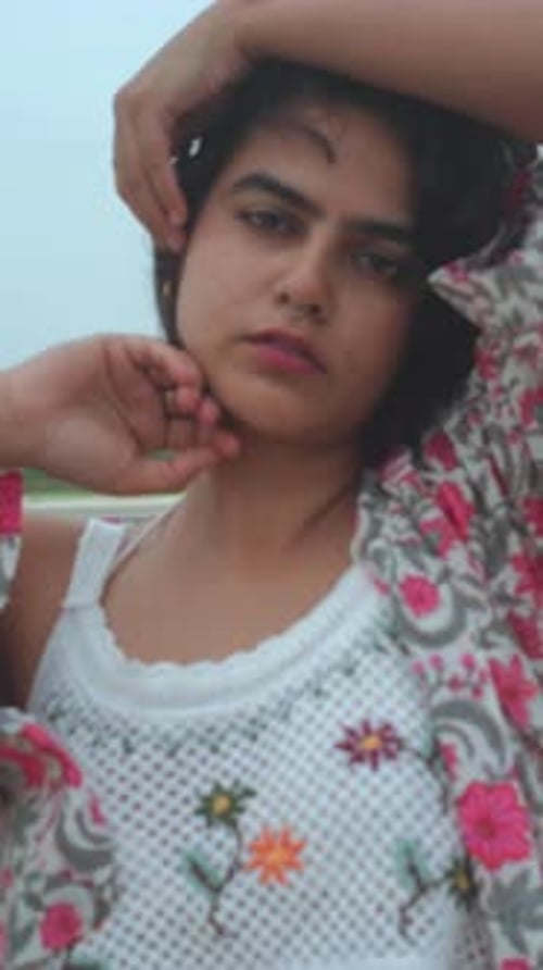 Young Woman in Floral Outfit at the Beach