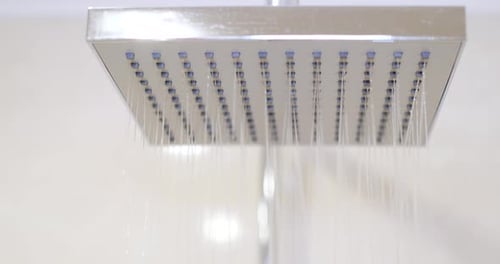 Shower Head Sprays Water in Bathroom