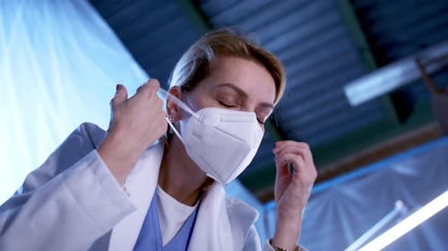 Tired and Frustrated Doctor by Patient in Bed in Hospital, Looking At