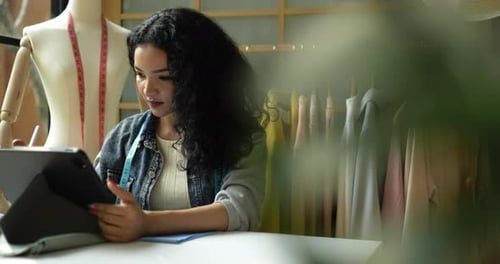 Fashion Designer Working on Tablet in Bright Studio