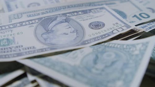 US Dollar Bills Scattered And Rotating In Slow Motion Paper American Cash