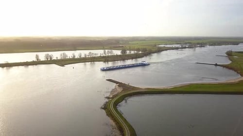 drone footage of the boat crossing the river or canal in 4K in Holland