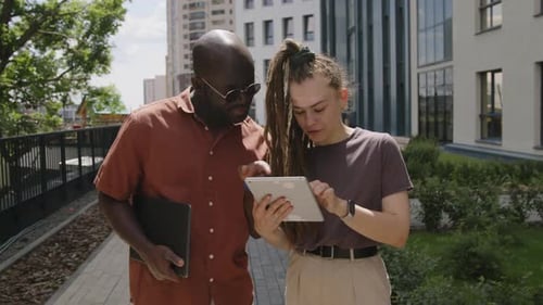 People Using Tablet in Urban Environment