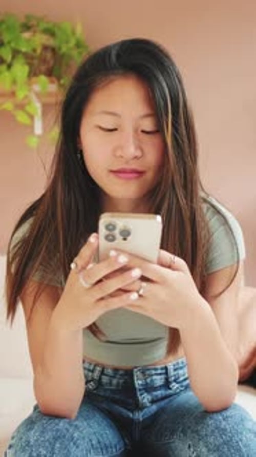 Young Woman Using Smartphone Indoors