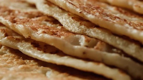 Pancakes with Condensed Milk on a Plate in a Restaurant Cutlery Knife and Fork Cut Delicious