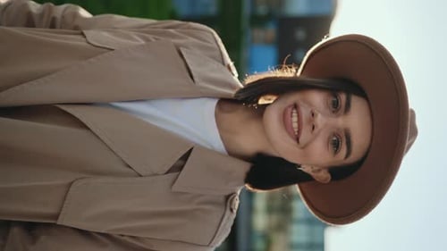 Vertical Video Portrait of the Charming Young Brunette Girl Wearing Brown Hat and Posing to the