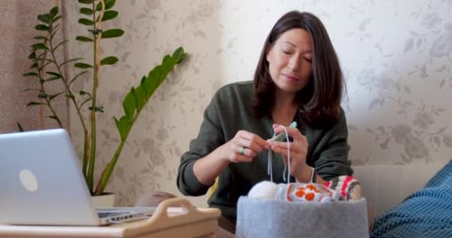 Woman Crocheting Yarn At Home Relaxing