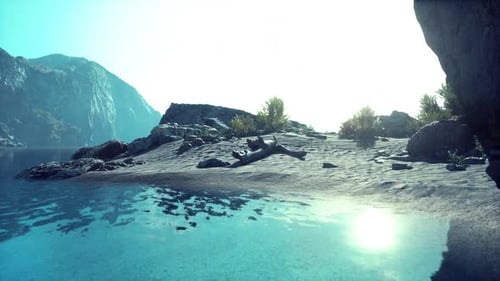 Serene Shoreline at Sunrise with Calm Waters and Rocky Landscape