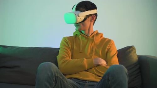 Young Adult Using VR Headset on Couch