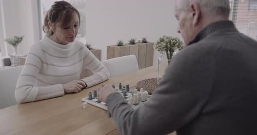 Senior Couple Playing Chess at Home Together