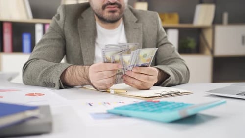 Businessman counting money.