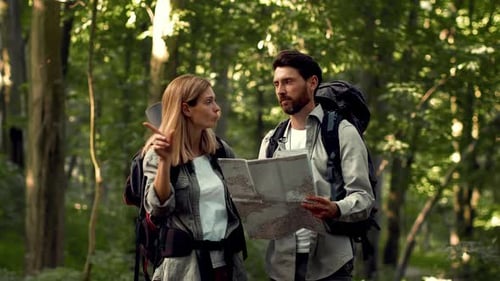 Emotional Man and Woman Tourists Getting Lost in Forest Arguing with Map Feeling Disagree Go in