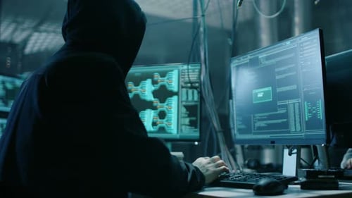 Hacker Coding with Multiple Computer Screens in Dark Room