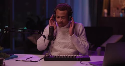 Man Singing and Playing Mini Keyboard in Studio