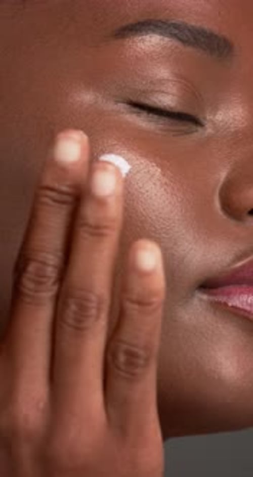 Cream, skincare and black woman with beauty, shine and dermatology on gray studio background
