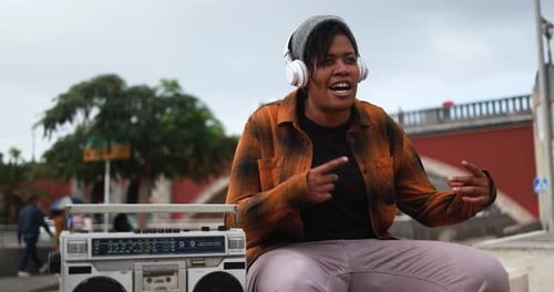 African American Woman Rapping a Song with City Streets in Background -