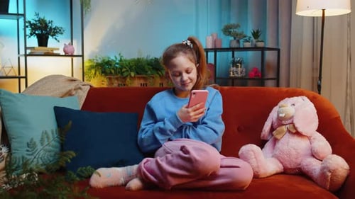 Girl Relaxing on Couch Using Smartphone