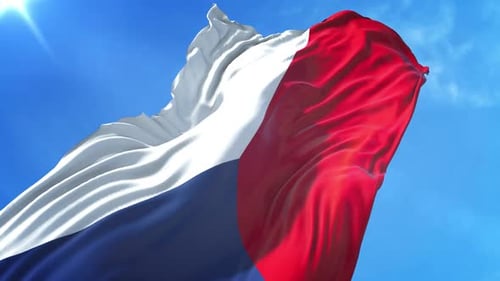 French Flag Waving In Wind Against Blue Sky