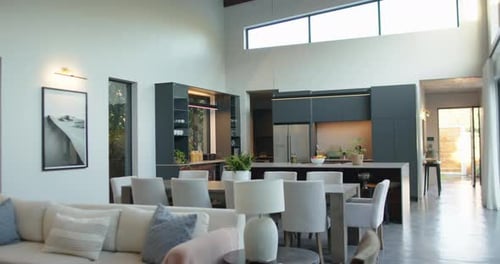 Modern kitchen and dining area with stylish furniture and natural light, copy space