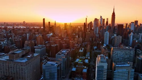 Flying over the cityscape of New York, the USA at sunset.