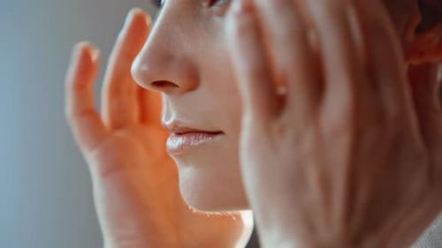 Woman Massaging Face in Beauty Routine