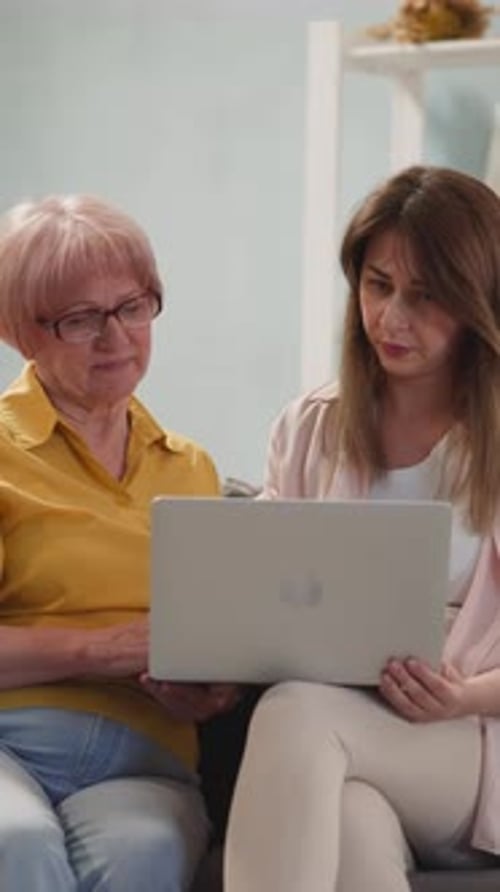 Adult and Senior Woman Using a Laptop Together