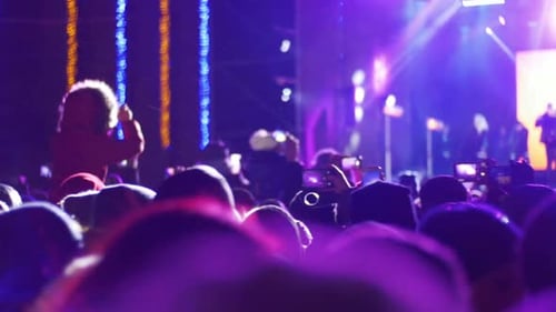 Crowd Making Party at a Rock Concert Hands Hold Cameras with Digital Displays