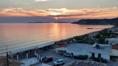 Golden Hour Coastal Bliss: A Serene Sunset Over a Greek Island Resort with Tranquil Sea Views,