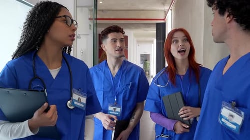Diverse medical students team talking in hospital hallway
