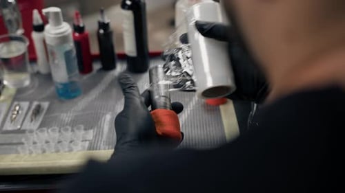 Tattoo Artist Prepares Equipment in Sterile Workplace