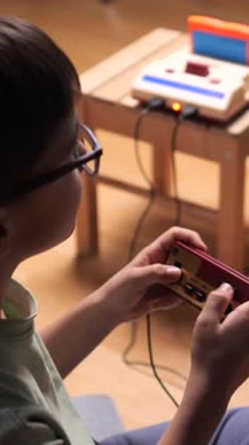 Child Plays Retro Video Game at Home